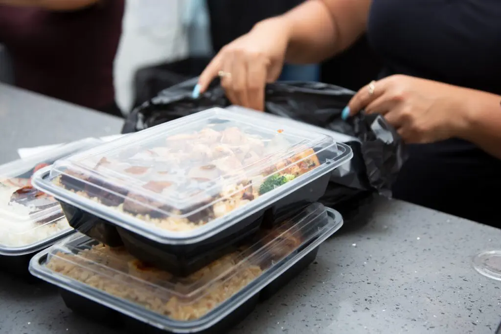 plastic food container to go with hands