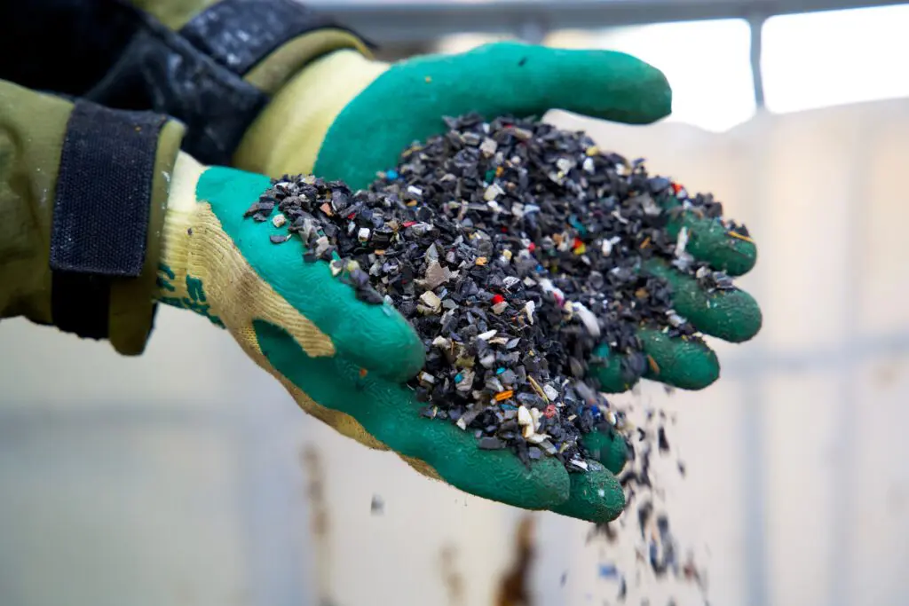 plastic scrap recycling output in hands