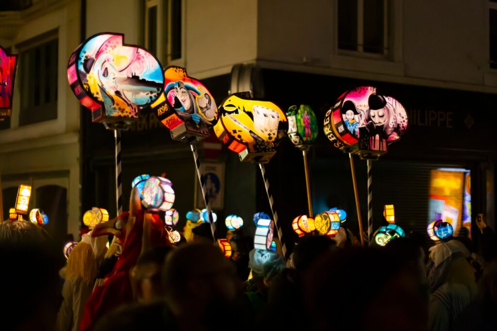 Carnival lanters at night on a busy street in Switzerland.